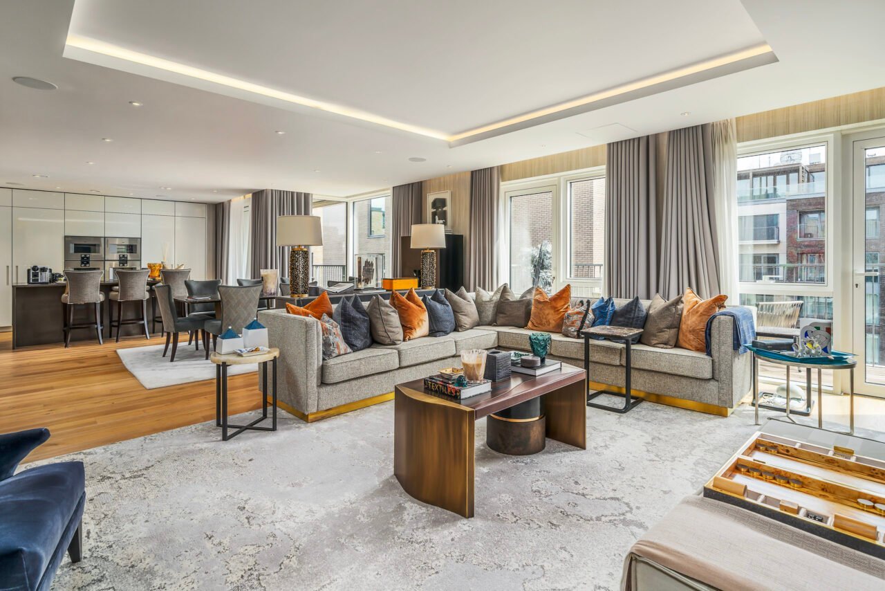 A spacious modern living room with large windows and stylish furniture.