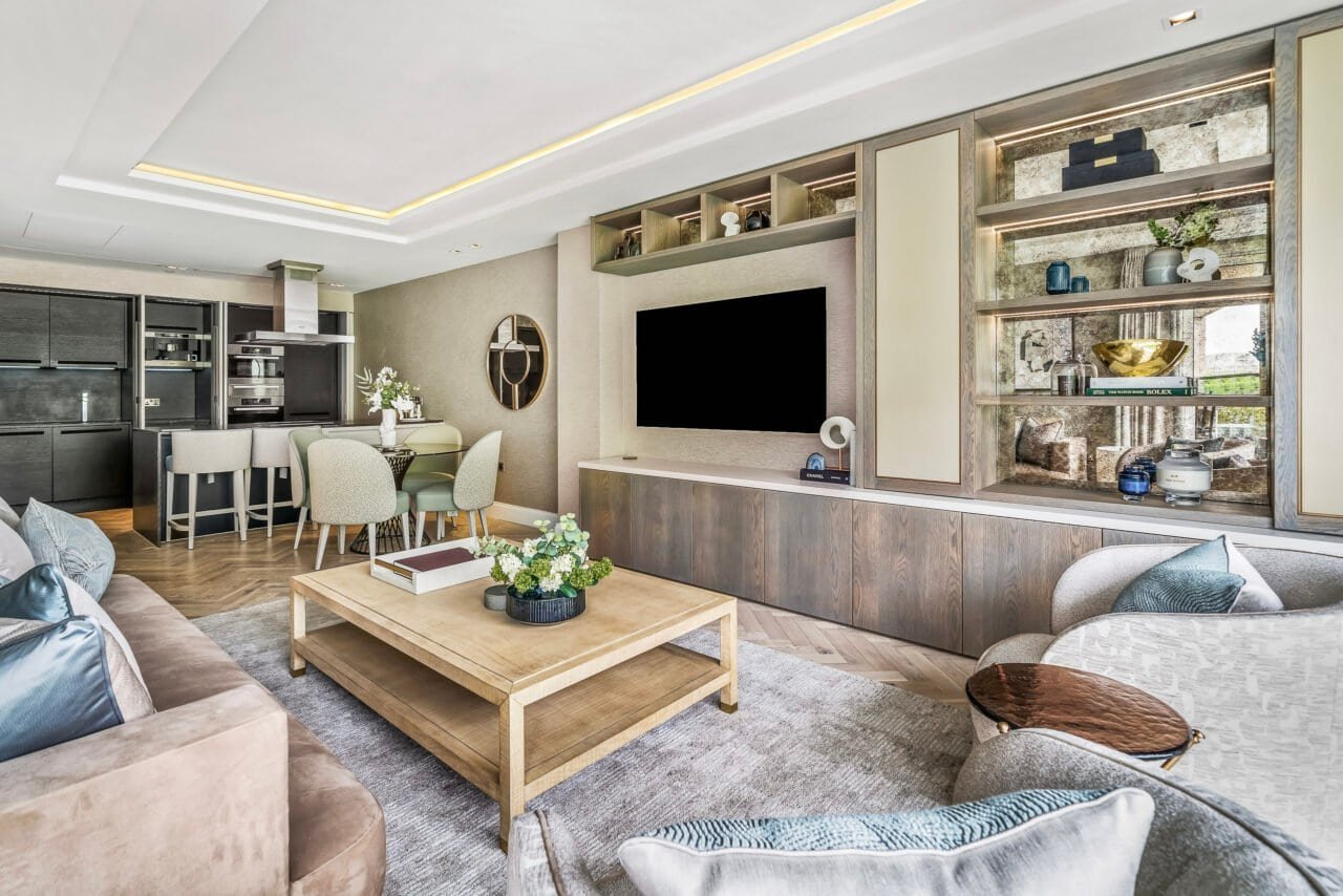 A modern living room with neutral tones, stylish furniture, and built-in shelving for home decor.