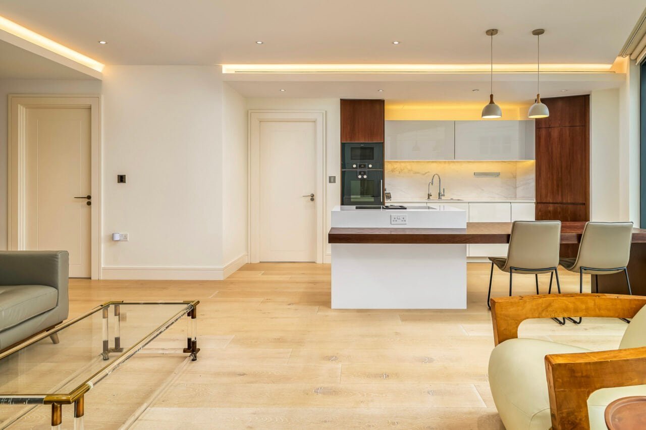 Modern open-plan kitchen and living room with minimalist design and natural light.