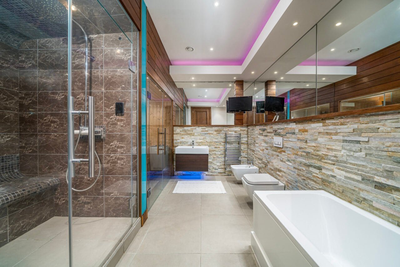 A modern bathroom with walk-in shower, bathtub, and contemporary decor.