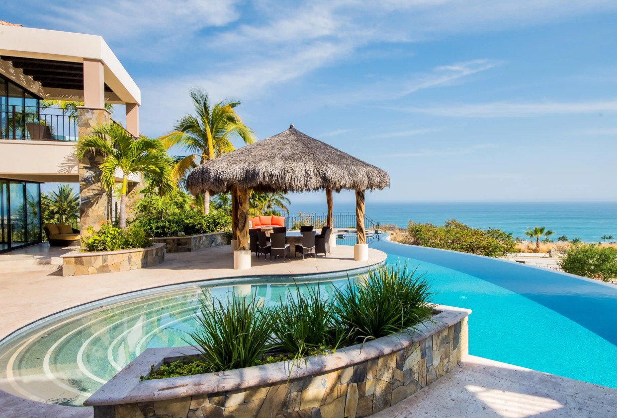 Luxurious Oceanview Villa Featuring An Infinity Pool, Palapa-Covered Dining Area, And Tropical Landscaping In Puerto Los Cabos Real Estate, San José Del Cabo.