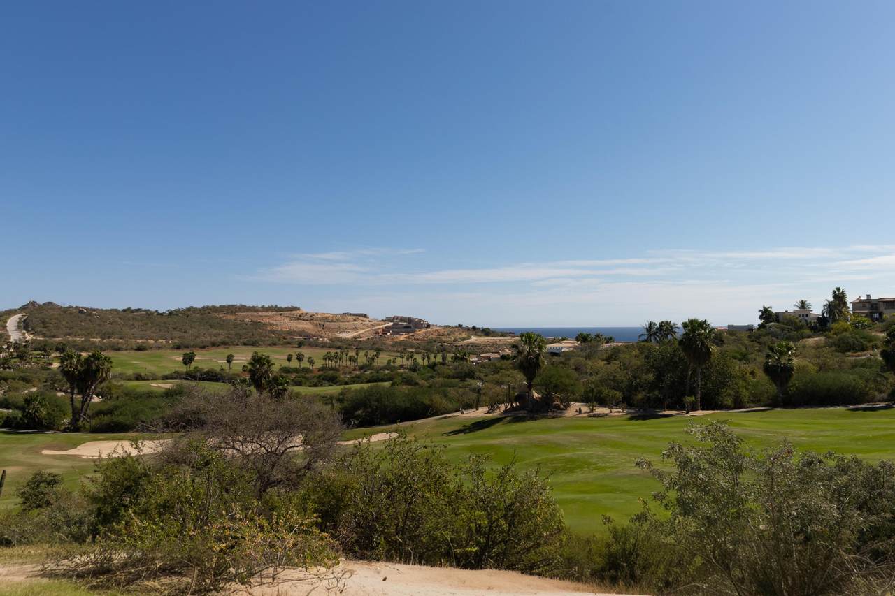 Puerto Los Cabos Golf Course With Scenic Landscape And Ocean View In The Background.