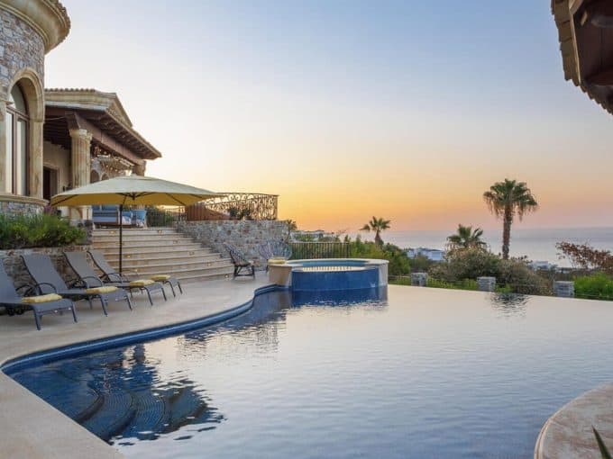 Home – Homes For Sale In Querencia Luxurious Stone-Clad Villa With Sun Loungers, Infinity Pool, And Sunset Ocean Views In Querencia Real Estate, San José Del Cabo.