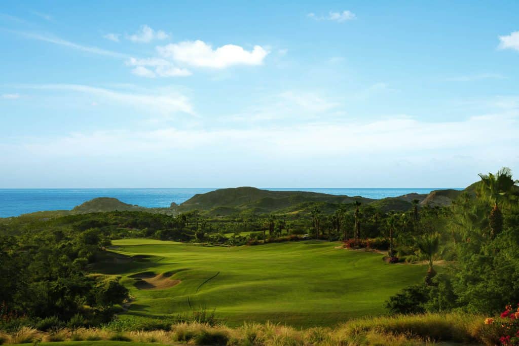 Querencia Golf Club In Los Cabos With Elevated Tee Shot, Desert Terrain, And Ocean Horizon