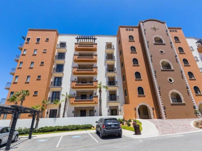 Exterior View Of Tower 5 Copala At Quivira, Showing The Mediterranean-Style Architecture, Balconies, And Parking Area In Cabo San Lucas, Baja California Sur