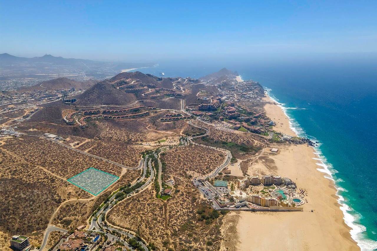 Luxurious Coastal Development At Quivira Los Cabos, Showcasing Hillside Properties And Ocean Views In A Prime Real Estate Location.