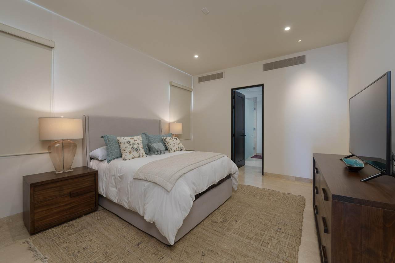 Luxurious Bedroom At Quivira Los Cabos Real Estate, Featuring Elegant Decor, Cozy Bedding, Modern Lighting, And A Spacious Layout For Ultimate Comfort.