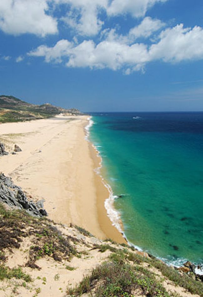High-Angle Scenic View Of The Secluded, Vast Golden Quivira Beach And The Vibrant Turquoise Pacific Ocean.