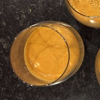 Refreshing golden turmeric beverage in a glass, healthy superfood drink.