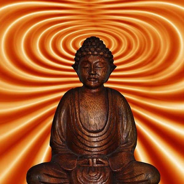 Wooden Buddha statue meditating against swirling orange background.