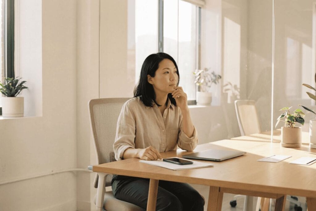 Woman contemplating enrolling in a wellbeing coach training course.