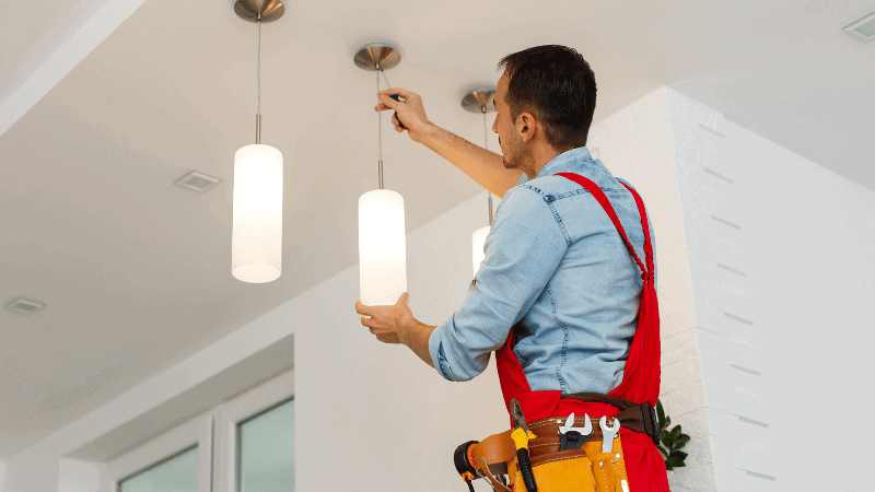 A man is installing lightings.