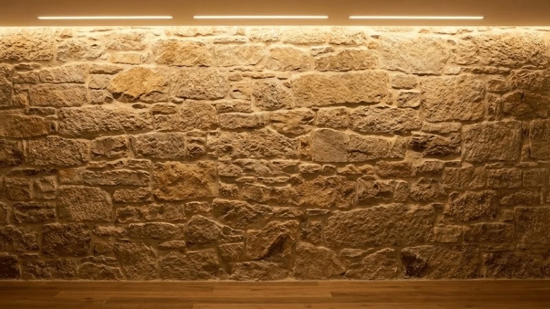 Warm-white wall washing lighting on stone wall
