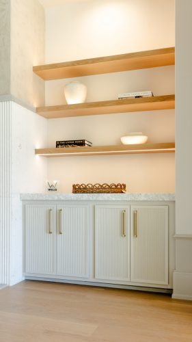 Bright, inviting living room with warm wood floors, soft beige furnishings, and minimalist decor creating a serene feel.