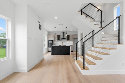 Contemporary kitchen detail with quartz island and High Tide wood composite floors