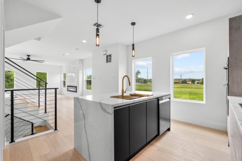 Bright kitchen with marble backsplash and durable water-resistant composite flooring