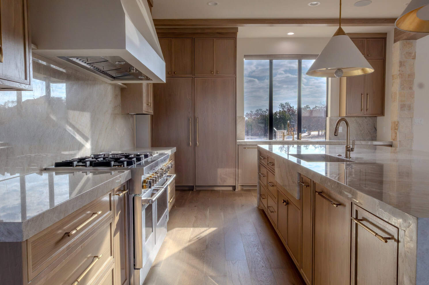 Killarney - Kingfisher Contemporary kitchen with neutral palette, custom cabinetry, and wide-plank wood floors