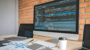 How Long Does It Take to Build a Website. Desktop computer monitor displaying code.