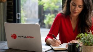 Woman working on branding strategy with laptop and notebook outdoors.