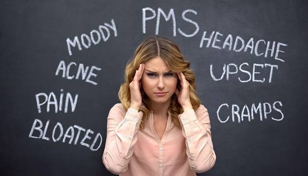 Chronic stress and hormonal symptoms causing headache and mood swings in women.