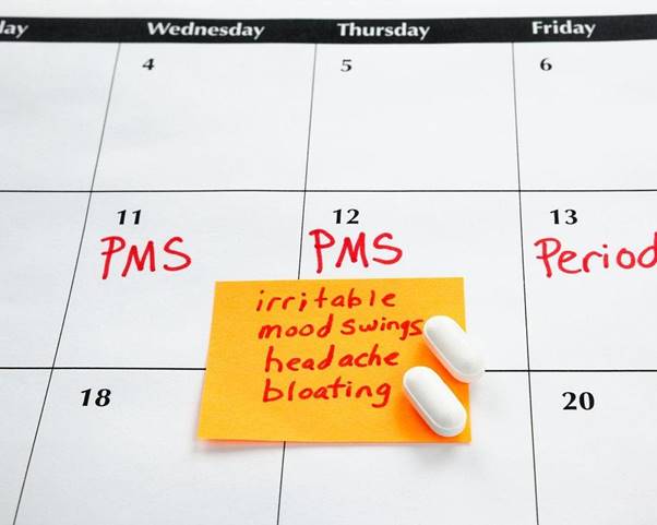 Relatable PMS symptom calendar with notes on mood swings and headaches.