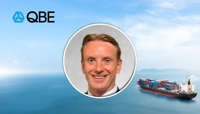 Profile photo of a smiling man with a circular frame over a maritime background, featuring the QBE logo in the upper left corner.