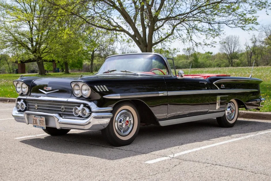 1950s vintage black Cadillac convertible parked outdoors with green trees in the background, showcasing classic car collectibles at RepoAuctionHouse.