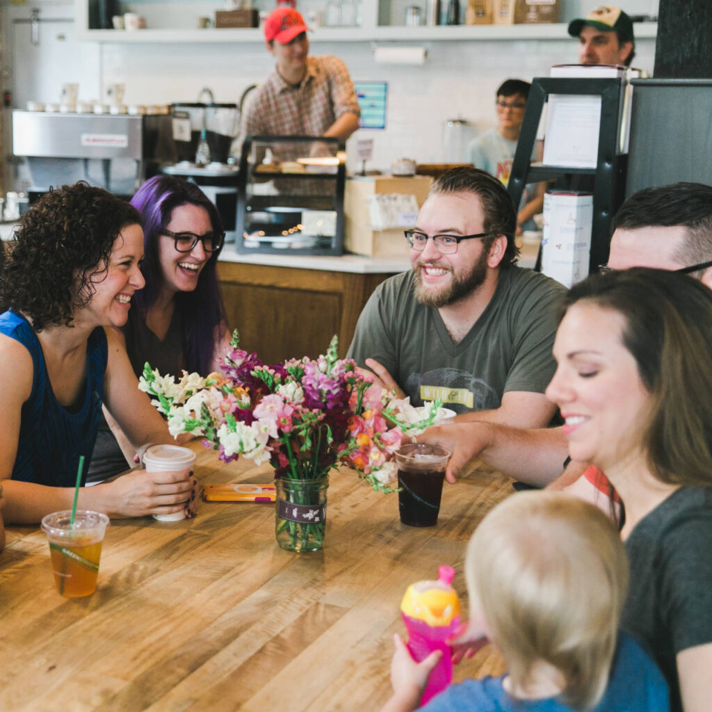 A group of people enjoying community at a cafe