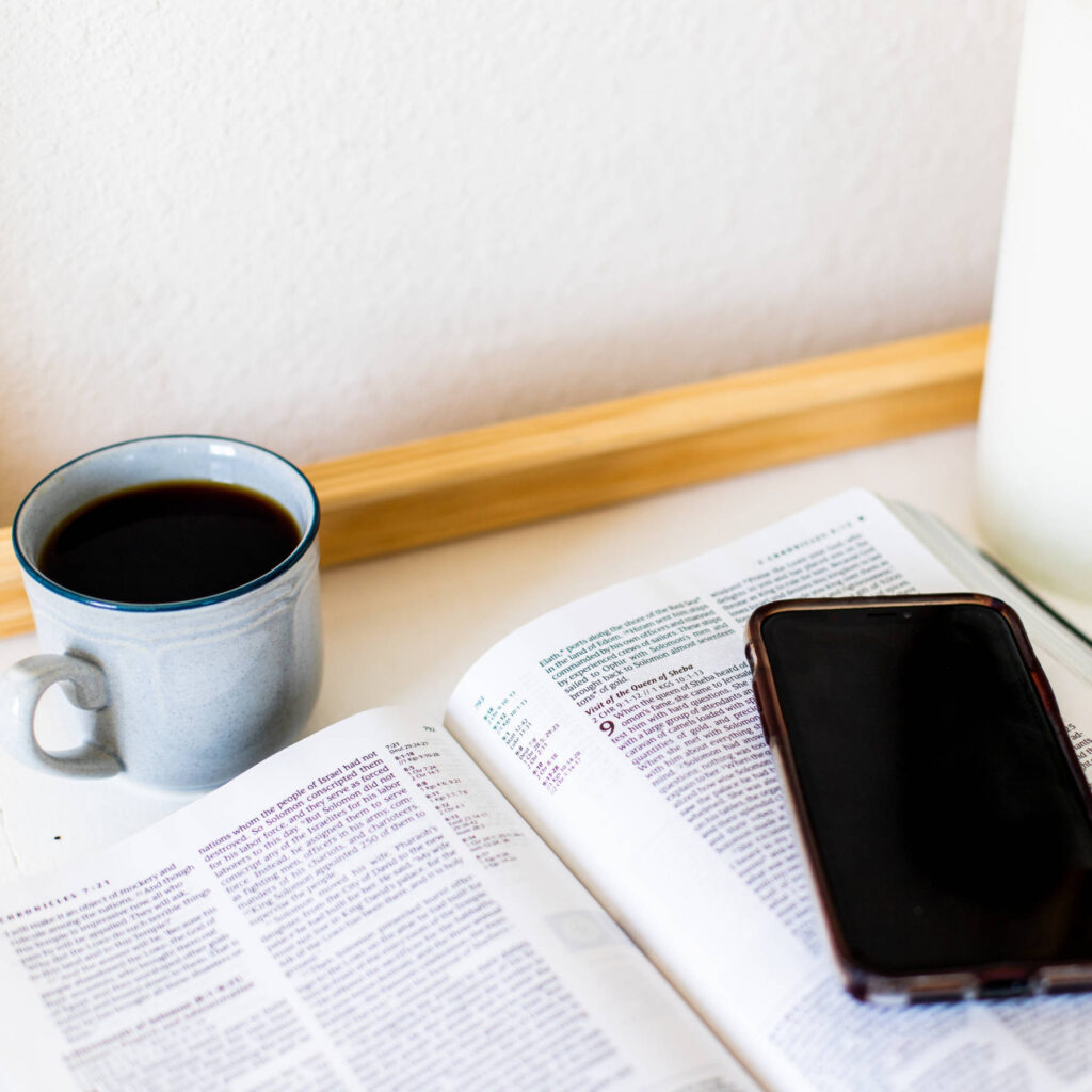 Phone sitting on top of a Bible
