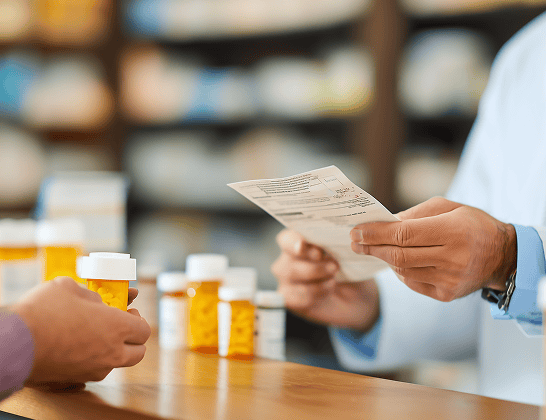 pharmacist handing prescription medication patient 1