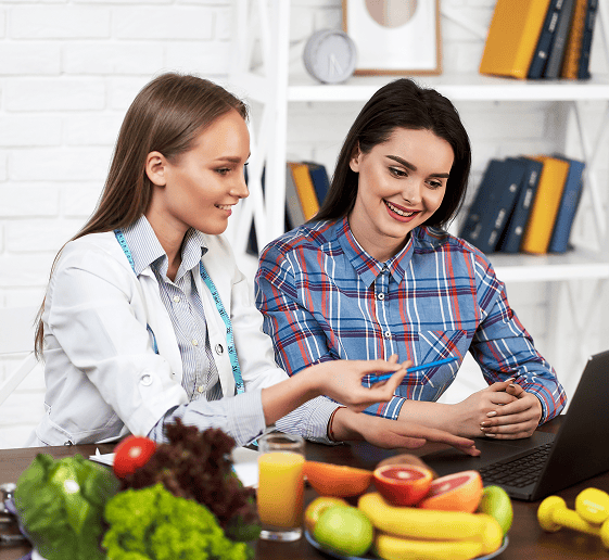 smiling nutritionist advises young patient woman proper nutrition dieting 1