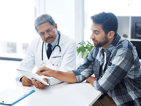 when last did you see doctor shot mature male doctor patient having discussion doctors office before checkup 1