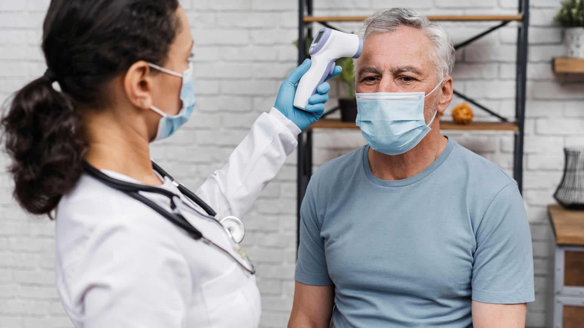 doctor taking patients temperature