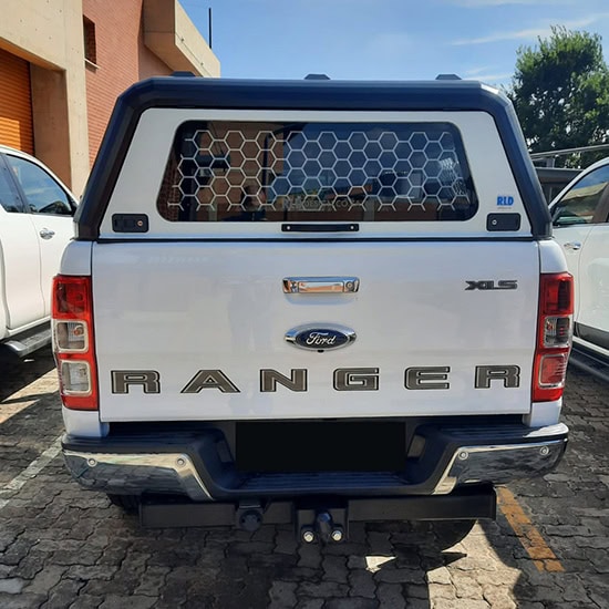 Stainless steel canopy installed on a Ford Ranger pickup truck, providing protection and enhancing vehicle aesthetics with custom design.