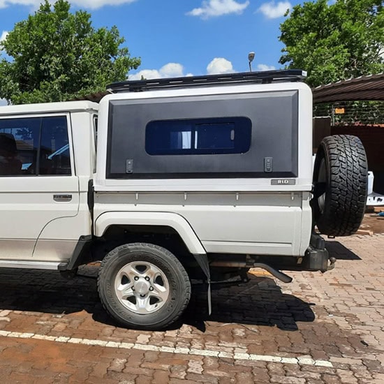 Stainless steel canopy installed on a white off-road vehicle, providing durable outdoor protection and enhanced vehicle style.