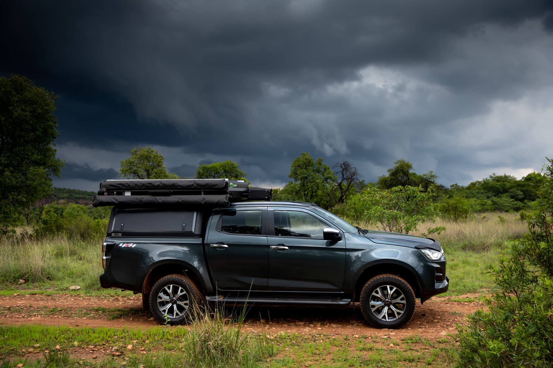 Durable stainless steel canopy on a rugged pickup truck in wilderness setting.