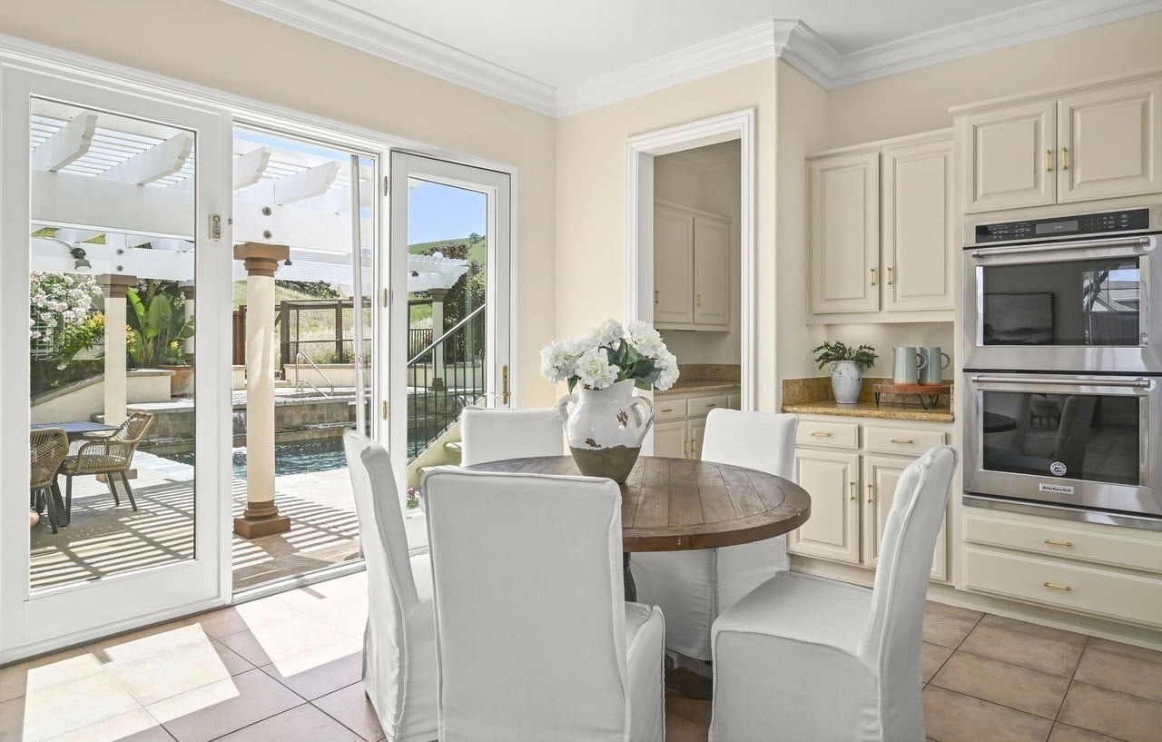 Sunny kitchen with dining table and view of backyard in Walnut Creek, CA.