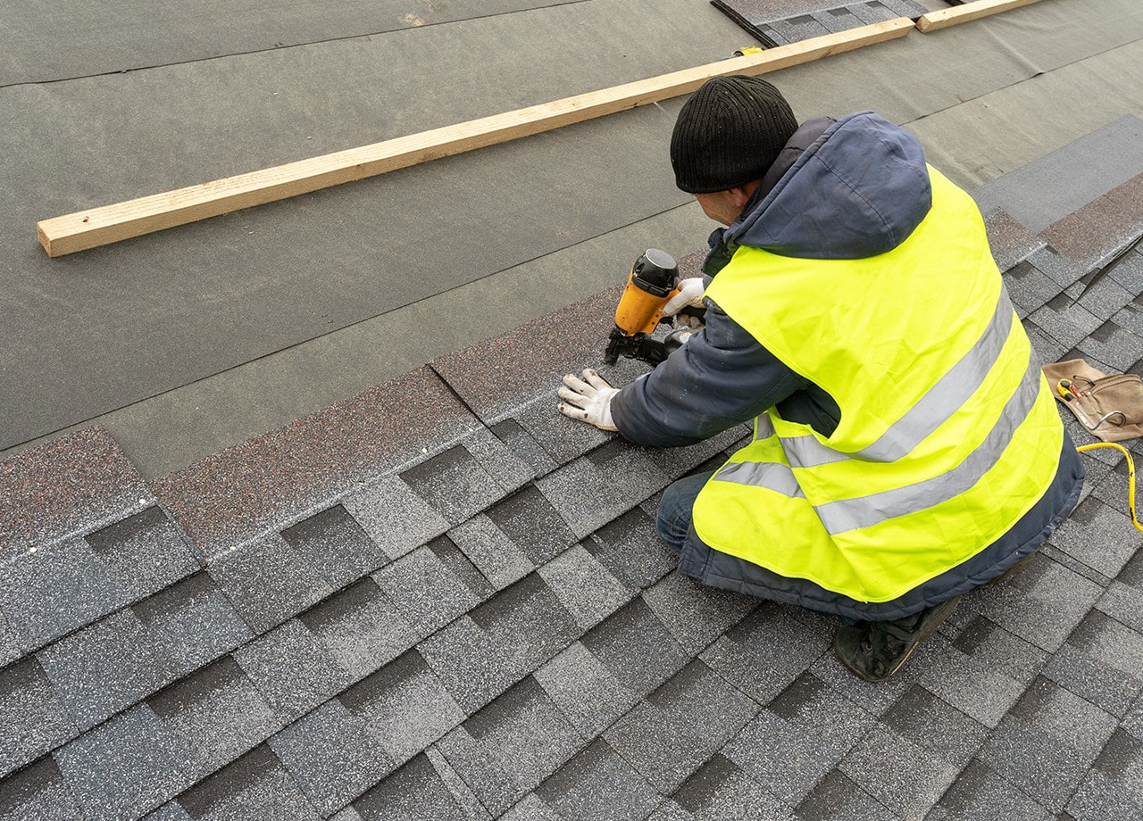 Asphalt-Shingle-Roof-Roofing-for-Troops-02 A photo of a roof with a gutter drain installed, advertising Roofing For Troops' gutter cleaning services