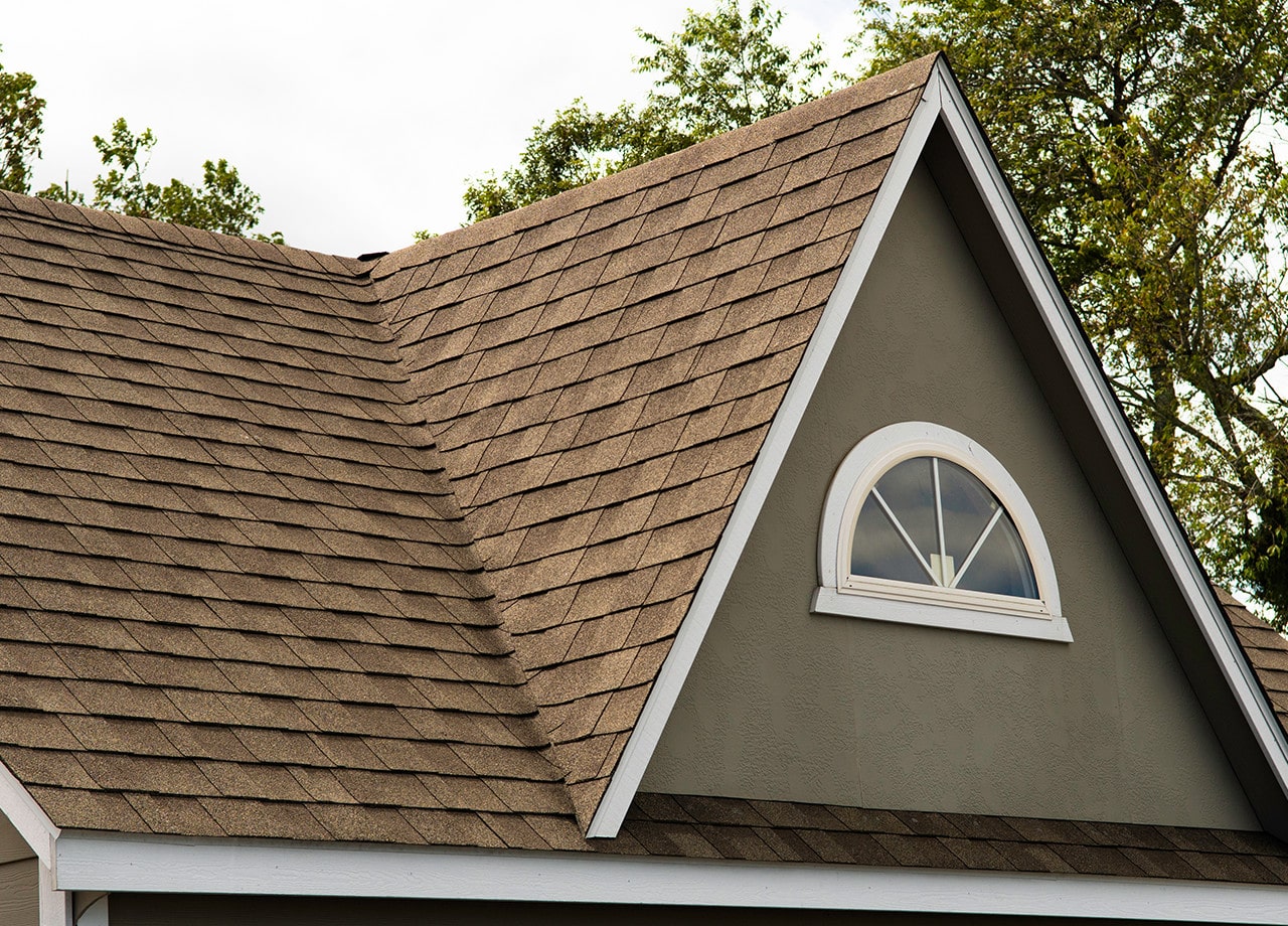 Asphalt-Shingle-Roof-Roofing-for-Troops-03 A photo of a roof with a gutter drain installed, advertising Roofing For Troops' gutter cleaning services