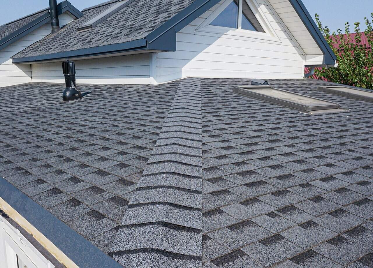 Asphalt-Shingle-Roof-Roofing-for-Troops-04 A photo of a roof with a gutter drain installed, advertising Roofing For Troops' gutter cleaning services