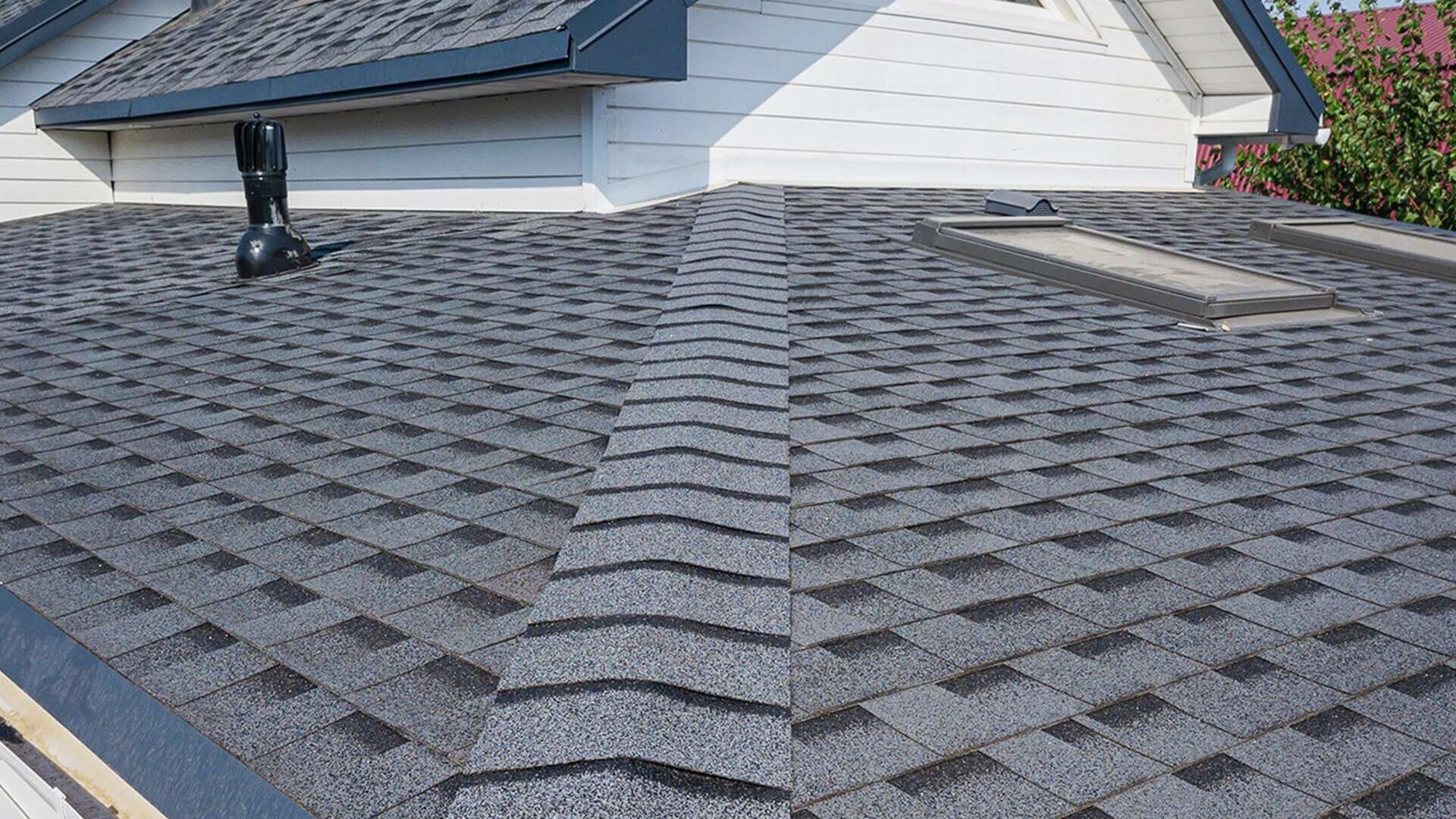 Asphalt-Shingle-Roof-Service-Roofing-for-Troops A photo of a roof with a gutter drain installed, advertising Roofing For Troops' gutter cleaning services