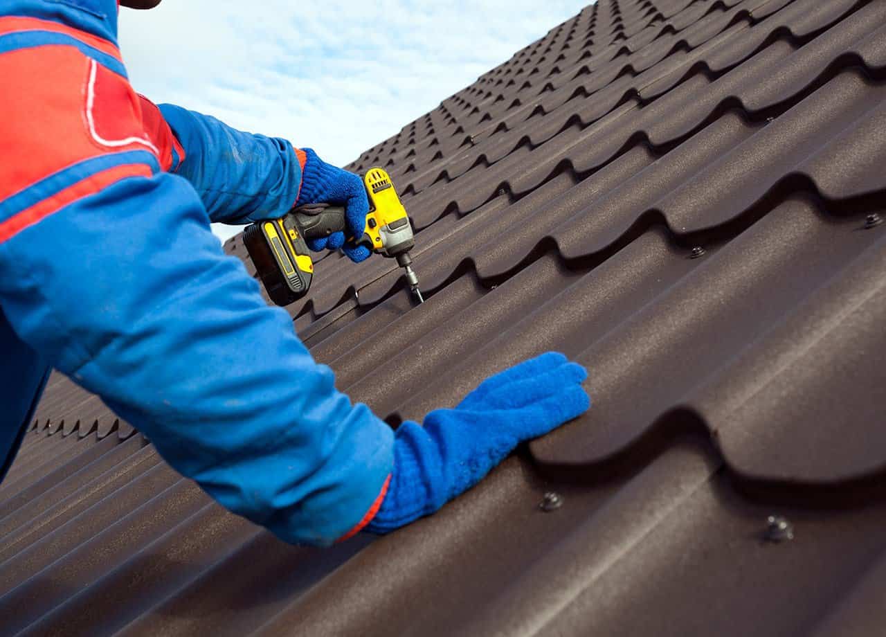 A photo of a roof with a gutter drain installed, advertising Roofing For Troops' gutter cleaning services