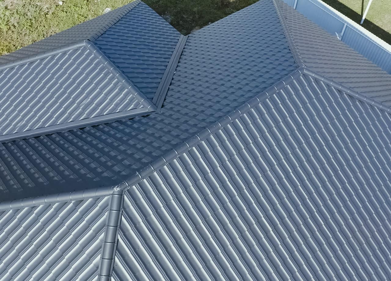 A photo of a roof with a gutter drain installed, advertising Roofing For Troops' gutter cleaning services