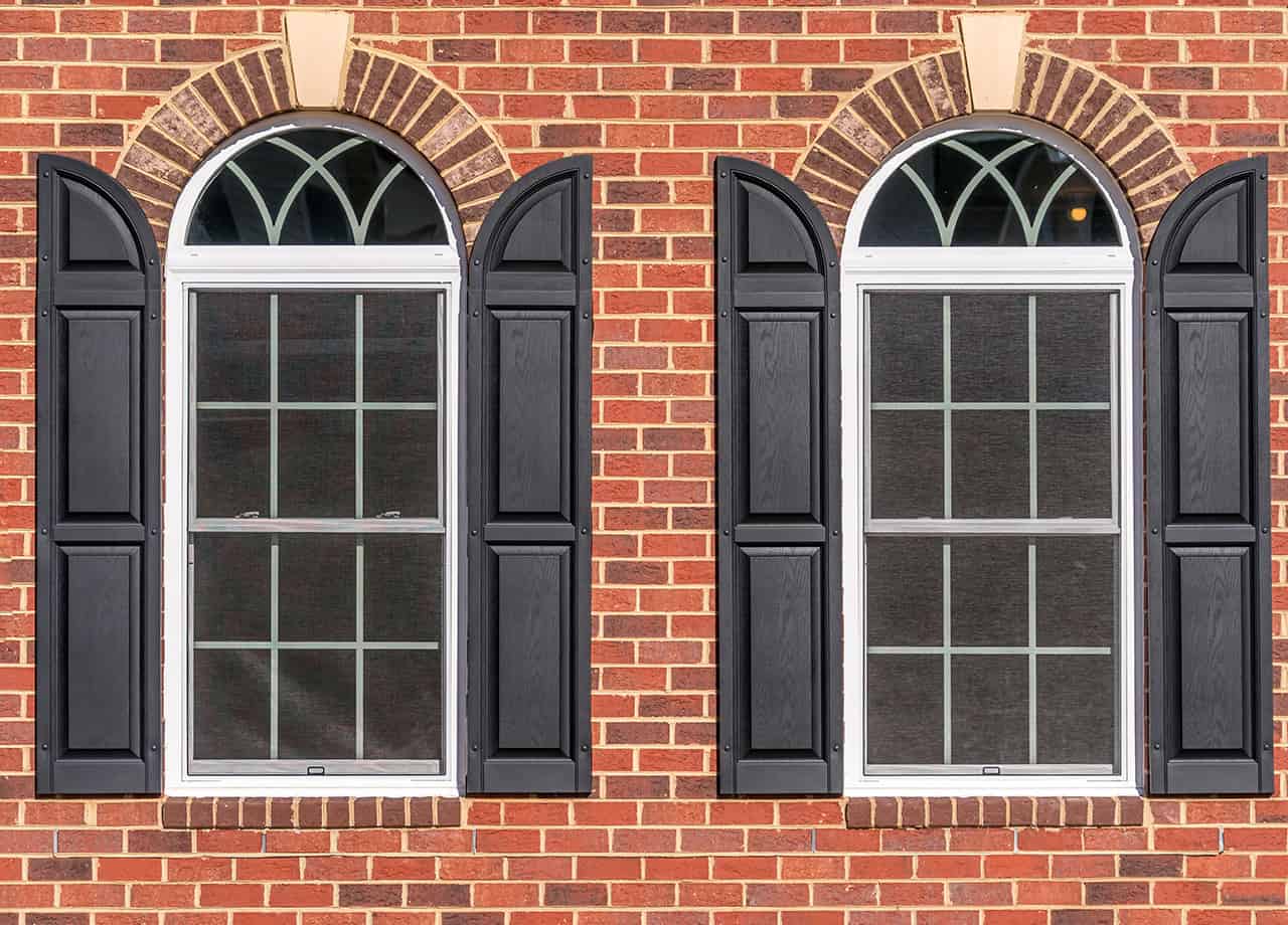 Brick siding installations near me Close up image of brick siding on a house with double pane arched windows. Our skilled siding contractors can install brick siding for your home in the Milford OH & Cincinnati OH areas.