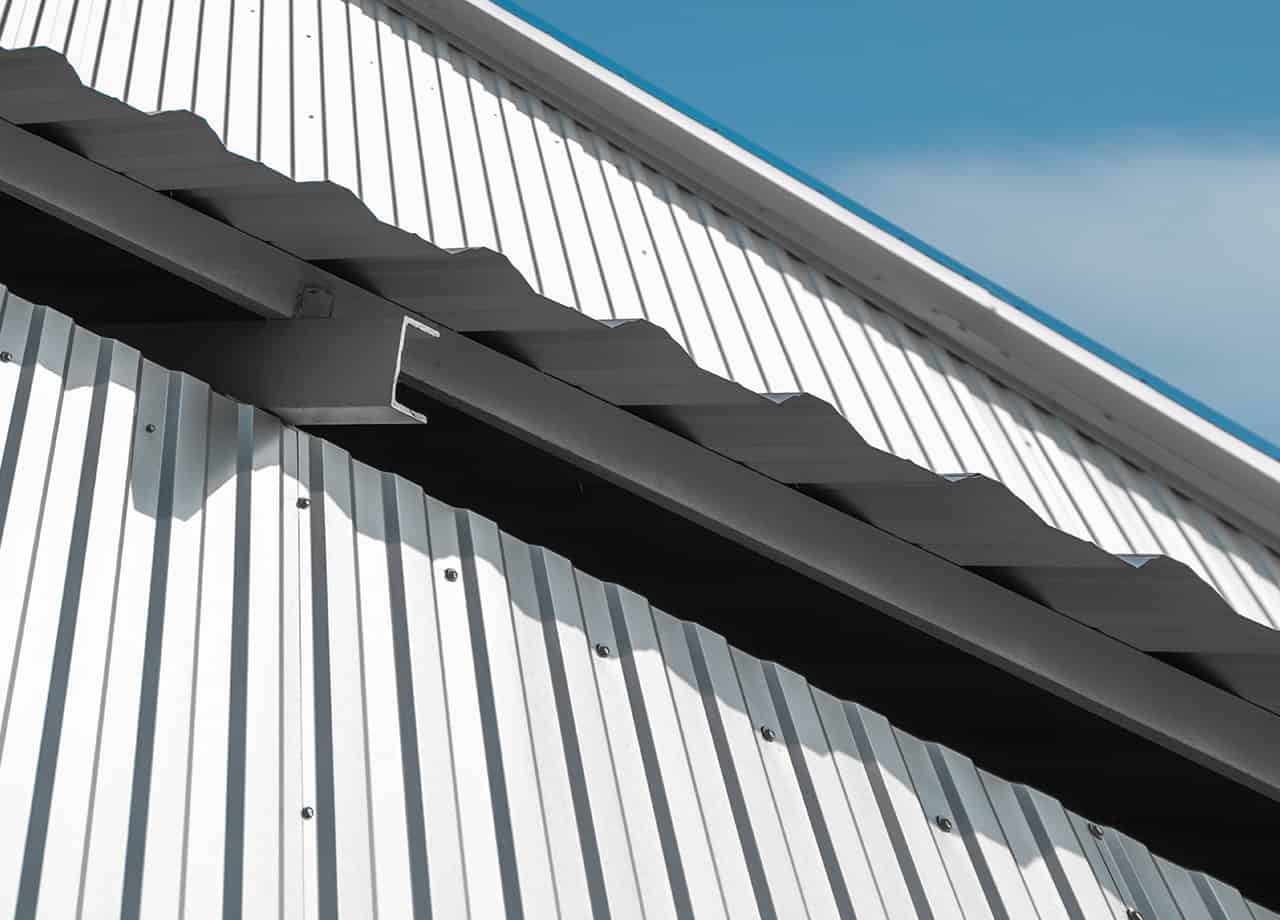 Metal siding contractors Close up image of white metal siding on a home. Our siding contractors install metal siding for homes in the Milford OH and Cincinnati OH areas.