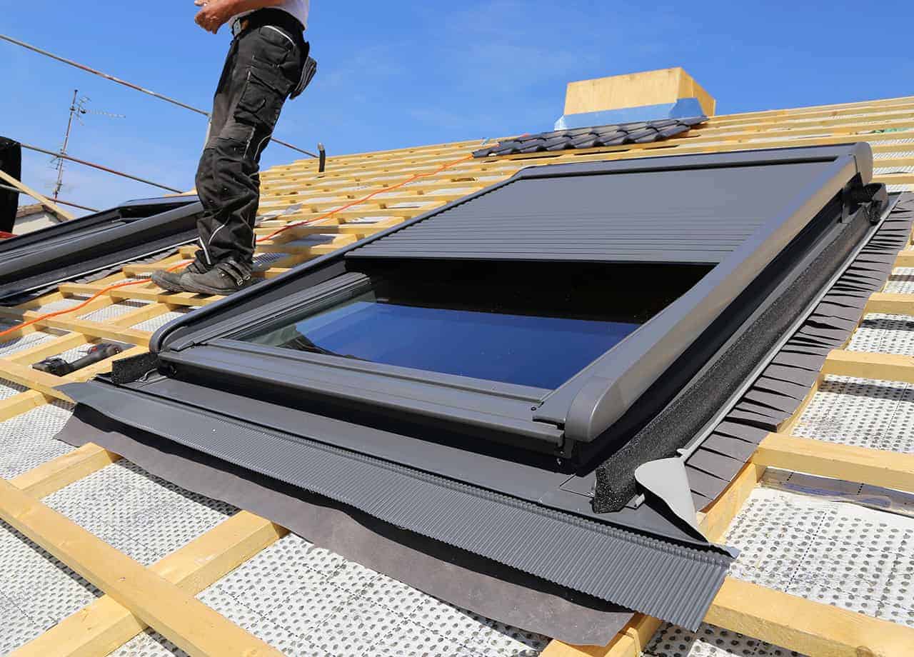 skylight installation for a home in Milford OH Roofing For Troops team members carefully installing a skylight on a roof in Milford OH.
