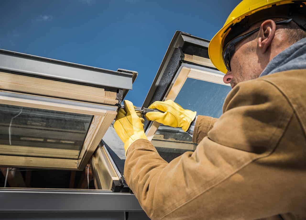 Image of our roofing contractor in Milford OH & Cincinnati OH repairing a skylight on the roof of a home.