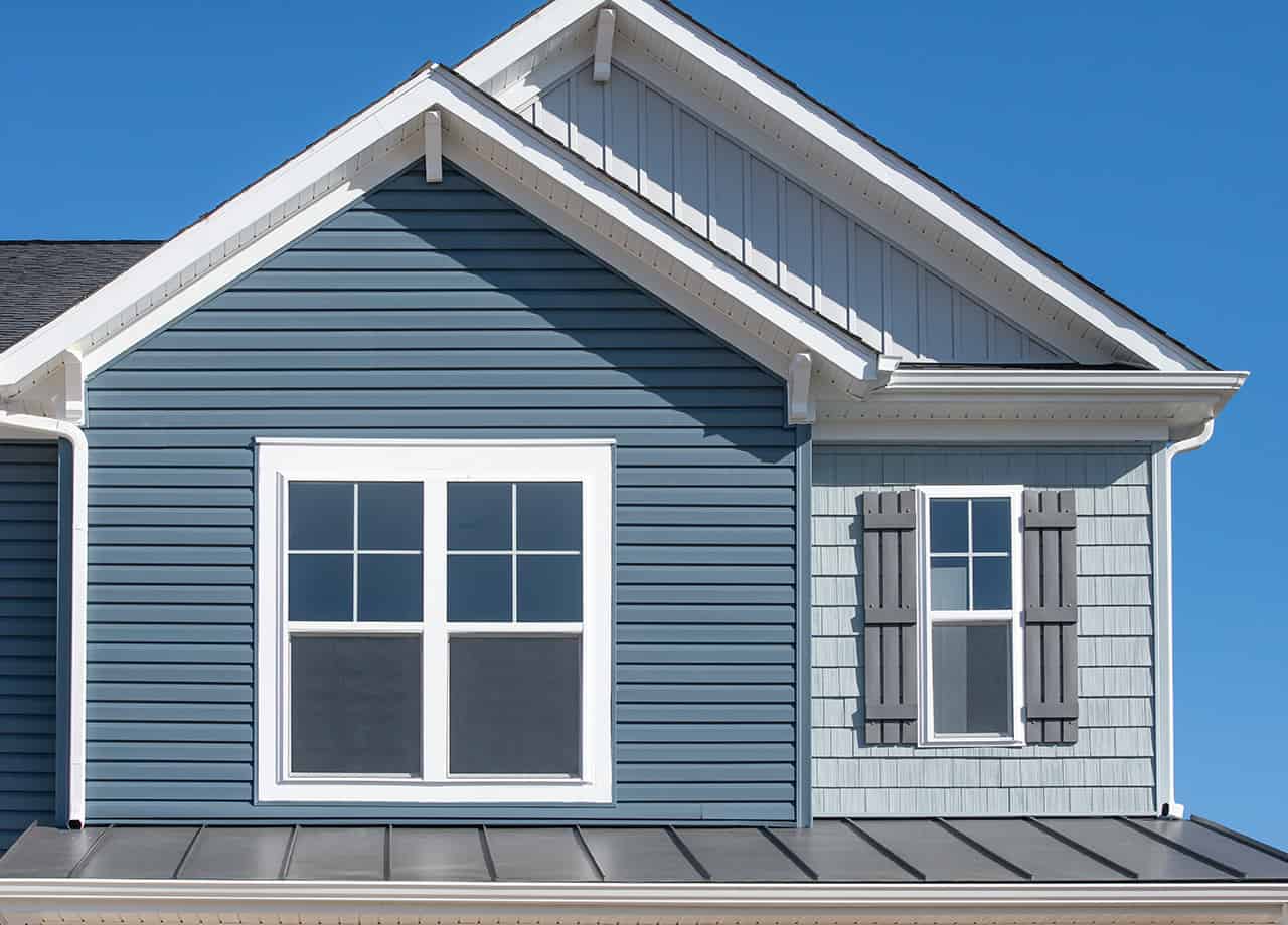 vinyl siding Milford OH _ Cincinnati OH Image of a home with blue vinyl siding in Milford OH. Roofing For Troops provides vinyl siding installation services.