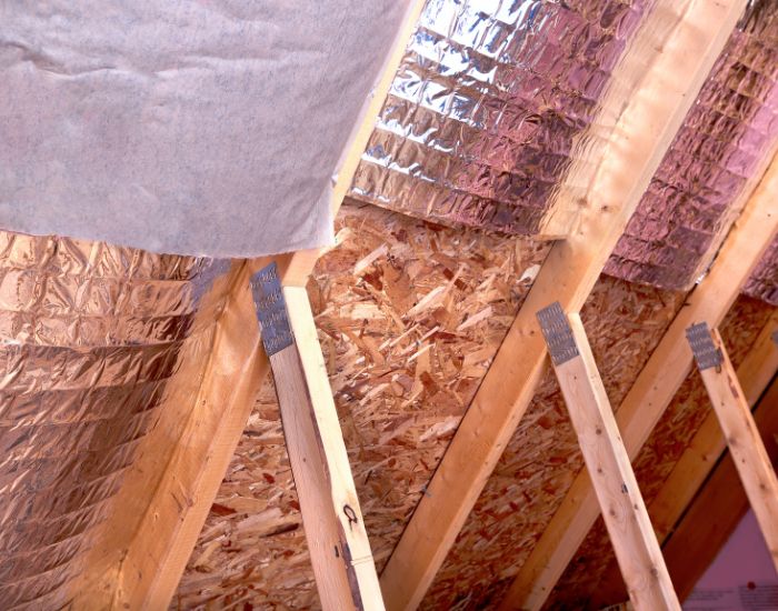 Attic Insulation in Ohio A photo of a roof with a gutter drain installed, advertising Roofing For Troops' gutter cleaning services