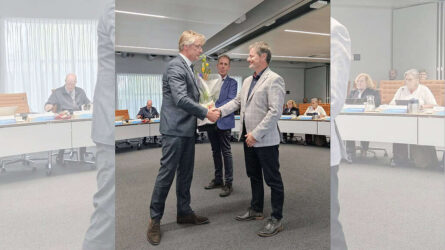 Uitreiking van een bloemenboeket tijdens een formele bijeenkomst bij RTV SLOS.
